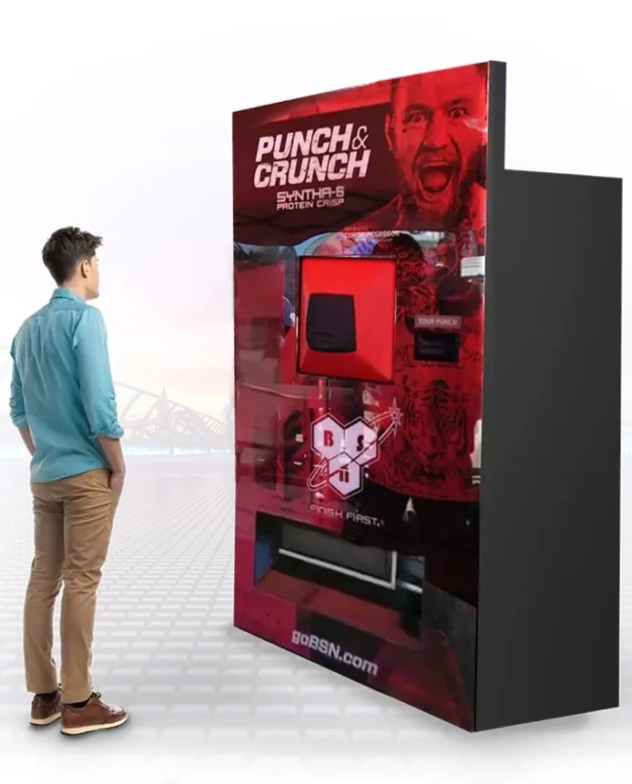 Punch & Crunch branded custom vending machine shown beside a standing shopper
