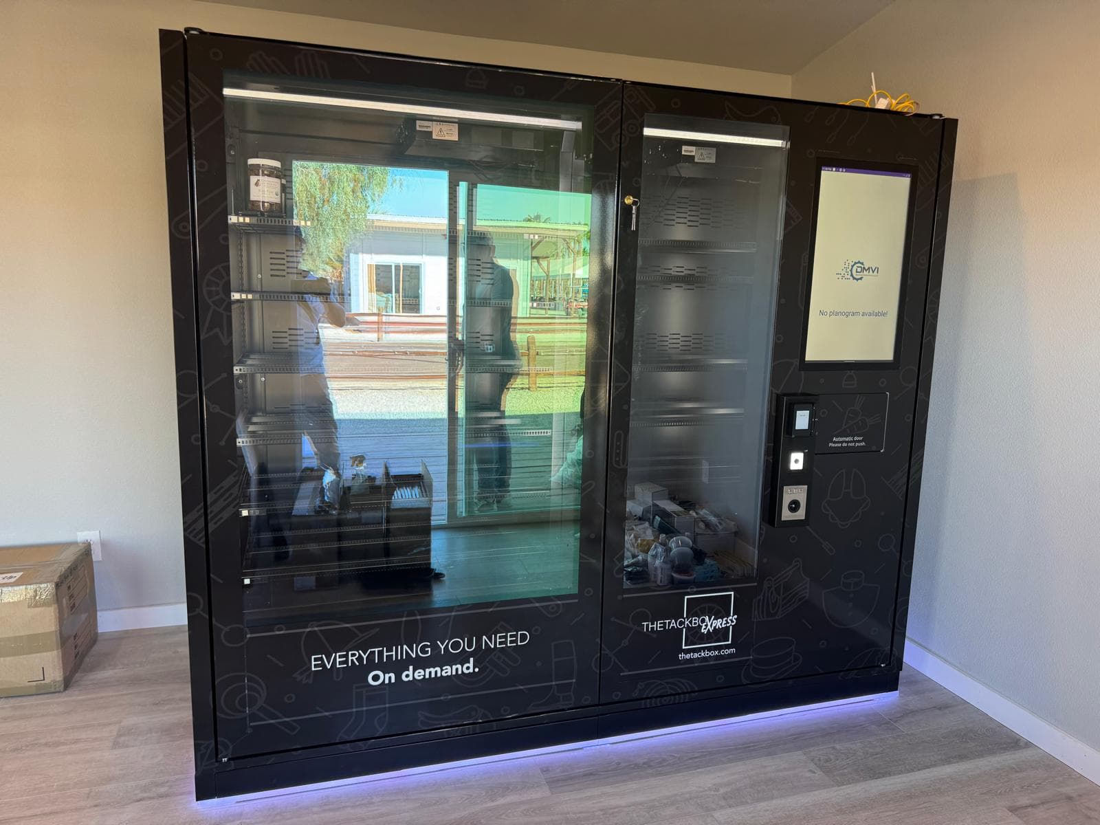 Installed DMVI M-Series autonomous retail machine with visible branding and interface