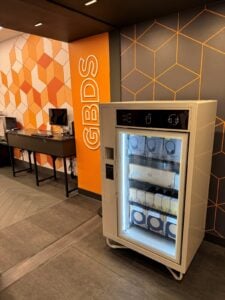 Custom vending machine in a busy area, offering gadgets, snacks and drinks to generate passive income from unused spaces.
