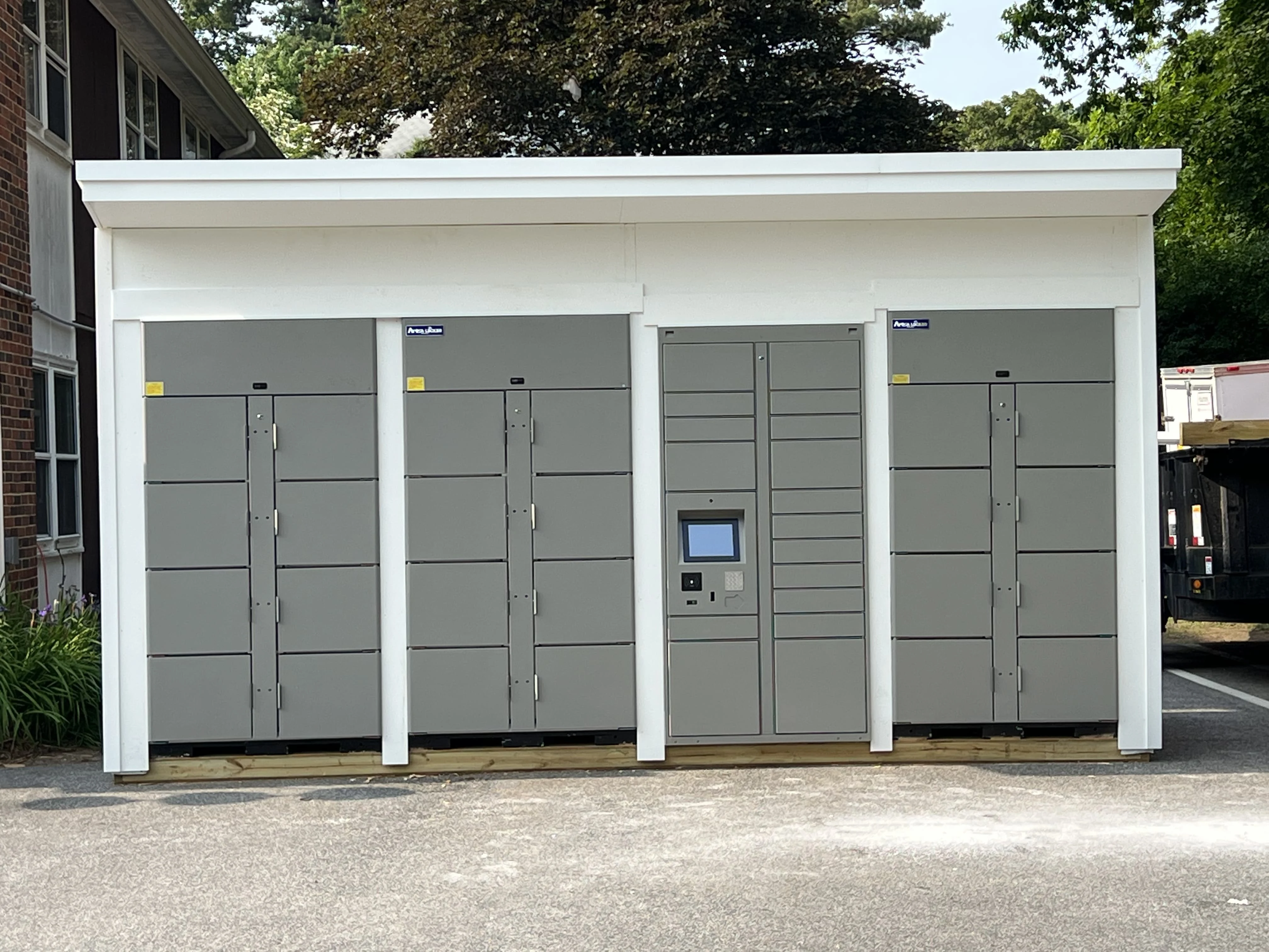 Grey locker bank installed inside a dedicated outdoor shelter